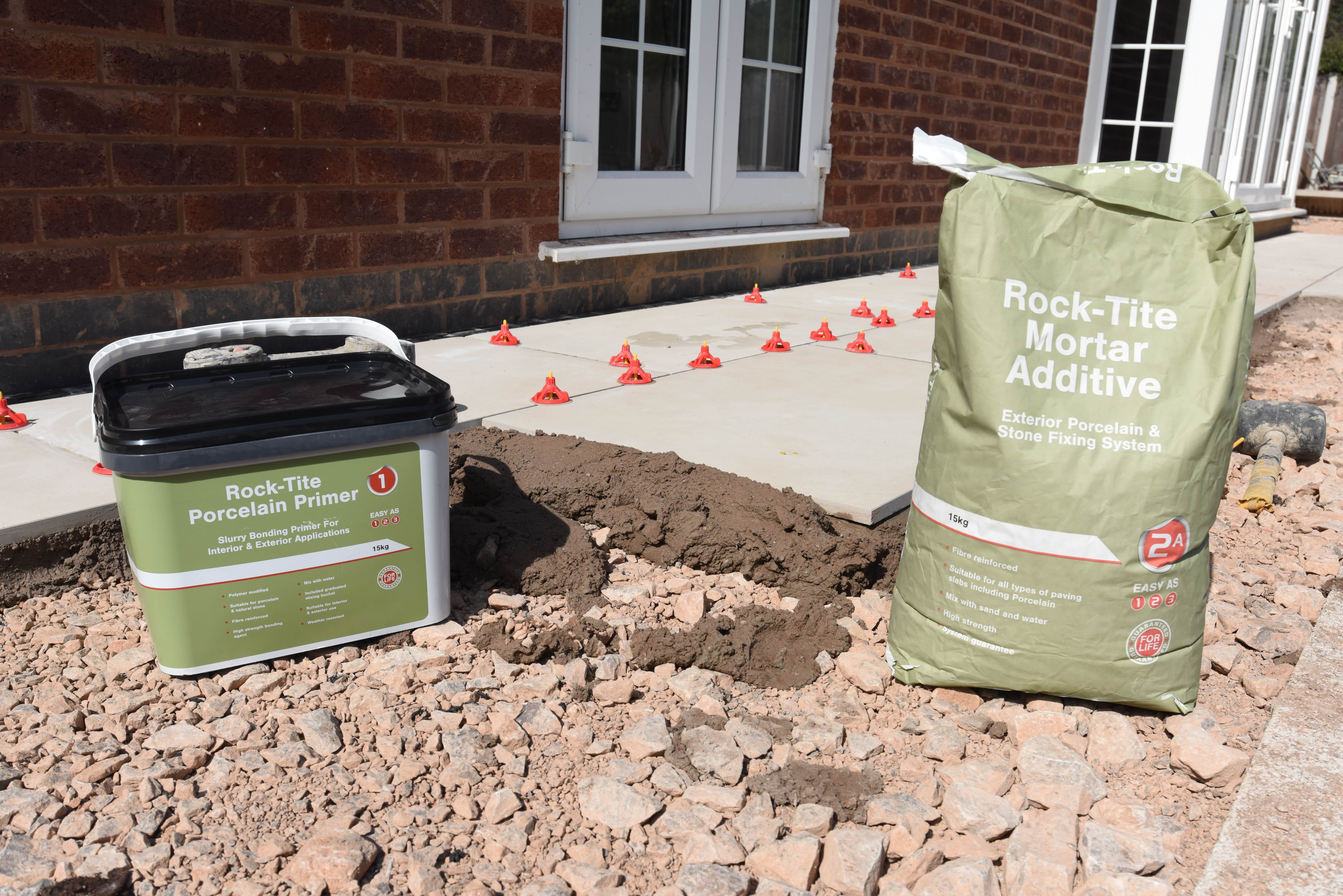 Tub of Rock - Tite Porcelain primer and a bag of Rock-Tite mortar addative