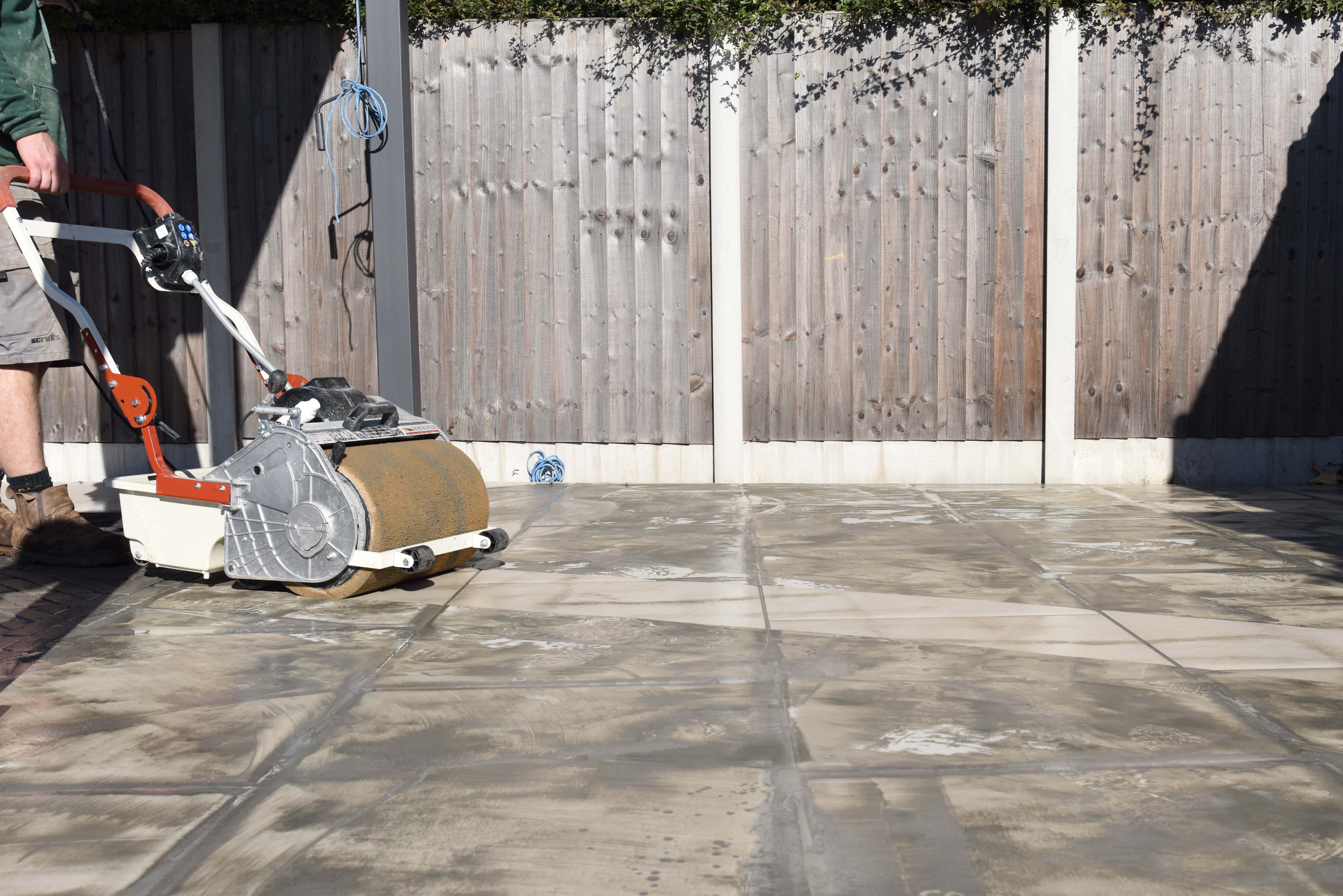 Final layer of Grout haze being removed from porcelain tiles using a sponge machine